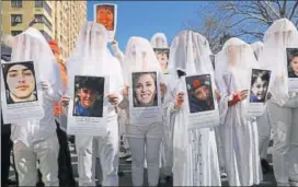  ?? AFP ?? Demonstrat­ors in New York carry the photos of victims of gun violence during a March for Our Lives rally in New York on Saturday.