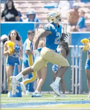  ?? ASHLEY LANDIS — THE ASSOCIATED PRESS ?? UCLA running back Zach Charbonnet runs for one of his three touchdowns against Hawaii at the Rose Bowl.