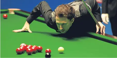  ?? Picture: PA. ?? Judd Trump lines up a shot during his shock first round defeat against qualifier Rory McLeod.