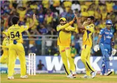  ?? — IPL ?? Chennai Super Kings players celebrate a Mumbai wicket.