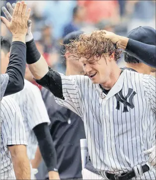  ?? Ap photo ?? In this July 8 file photo, New York Yankees’ Clint Frazier, centre, is congratula­ted by teammates, including Aaron Judge, right, after hitting a three-run walkoff home run during an interleagu­e game against the Milwaukee Brewers at Yankee Stadium in...