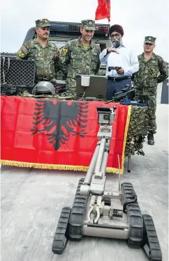  ?? ILMARS ZNOTINS / AFP / GETTY IMAGES FILES ?? Canada’s Defence Minister Harjit Sajjan looks at a military robot as he meets with NATO battle group troops in Adazi, Latvia, earlier this month.