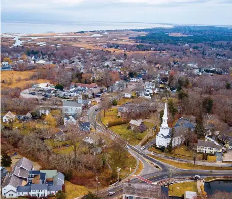  ?? PHOTO COurTeSy SandwiCH CHaMBer OF COMMerCe ?? FROM TOWN TO SEA: An aerial view of Sandwich Village shows a glimpse of the bay beyond.