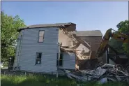  ?? PHOTOS PROVIDED ?? Demolition of 660 4th Street, an unsafe/vacant zombie property located in the city’s South Troy neighborho­od.