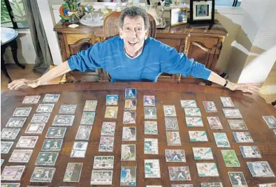  ?? CHRISTINE COTTER/COURTESY ?? Jerry Dworkin owns 117 Mike Piazza cards during his five game stint with the Marlins. The corporate lawyer from California is still searching for five cards he’s missing to complete his collection.