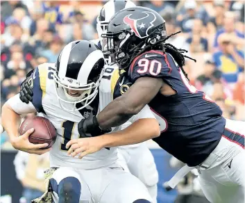 ?? HARRY HOW/ GETTY IMAGES ?? Houston Texans’ Jadeveon Clowney sacks Jared Goff, of the Los Angeles Rams, during the first half at the Los Angeles Memorial Coliseum on Nov. 12, in Los Angeles, Calif.