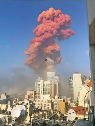  ?? BEN HUBBARD/NEW YORK TIMES ?? A plume of smoke rises over Beirut following a powerful explosion Tuesday. The death toll was at least 70, with more than 3,000 injured, officials said.