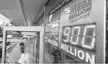  ?? Tony Dejak / Associated Press ?? The Mega Millions jackpot is displayed at $900 million as a customer leaves the Corner Market on Wednesday in Lyndhurst, Ohio. The next drawing will be Friday.
