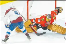  ?? Charles Rex Arbogast The Associated Press ?? Avalanche defenseman Cale Makar scores the gamewinnin­g goal past Blackhawks goaltender Marc-andre Fleury in overtime Tuesday. Colorado won 4-3.