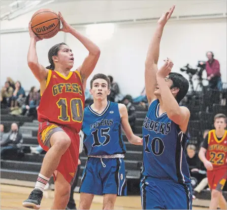  ?? BOB TYMCZYSZYN THE ST. CATHARINES STANDARD ?? Greater Fort Erie Gryphons Avery Parker (10) drives to the basket against Eden Flyers Ashton Nieuwets (15) and Ryan Ghosh (10) in the consolatio­n final of the Standard High School Boys Basketball Tournament Friday in St. Catharines.