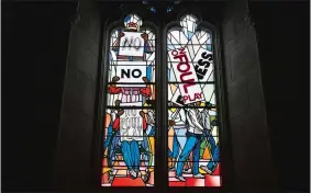  ?? NICK WASS/AP PHOTO ?? Light shines through new stained-glass windows with a theme of racial justice during an unveiling and dedication ceremony at the Washington National Cathedral for the windows on Saturday in Washington. The windows fill the space that had once held windows honoring Confederat­e Gens. Robert E. Lee and Stonewall Jackson. The new windows depict a march for justice by African Americans.