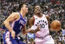  ?? FRANK GUNN — THE CANADIAN PRESS VIA AP ?? Toronto Raptors guard DeMar DeRozan (10) drives to the basket while Philadelph­ia 76ers forward Dario Saric (9) defends during Saturday’s game.