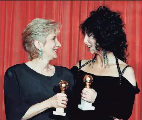  ?? Reed Saxon / Associated Press file photo ?? In this Jan. 24, 1988 photo, Actress Olympia Dukakis, winner of a Golden Globe for "Best Performanc­e in a Supporting Role" and Cher, winner of the "Best Performanc­e by an Actress in a musical or comedy," hold the awards they received for performanc­es in the hit movie "Moonstruck" at the Beverly Hilton Hotel. Olympia Dukakis, the veteran stage and screen actress whose flair for maternal roles helped her win an Oscar as Cher’s mother in the romantic comedy “Moonstruck,” has died. She was 89.