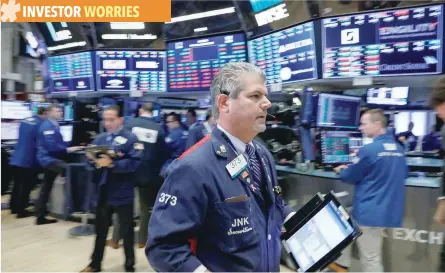  ?? — Reuters ?? Traders work on the floor of the New York Stock Exchange in New York.