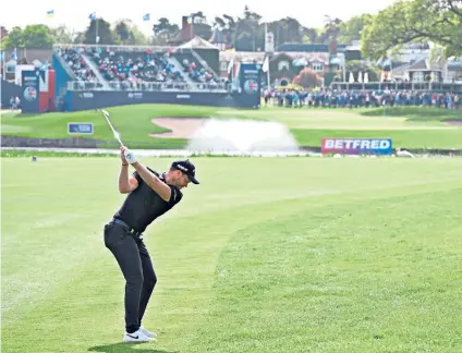  ?? ?? Final flourish: Danny Willett plays his second shot to the 18th hole, where a par four completed a seven-under round of 65