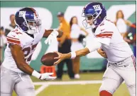  ?? Jeff Zelevansky / Getty Images ?? Giants quarterbac­k Davis Webb hands off to Darian Thompson during their preseason game against the New York Jets Friday at MetLife Stadium in East Rutherford, N.J.