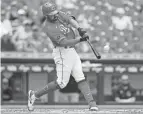  ?? AARON DOSTER/AP ?? The Reds' Eugenio Suarez hits a two-run home run during the second inning against the Rockies on Sunday in Cincinnati.