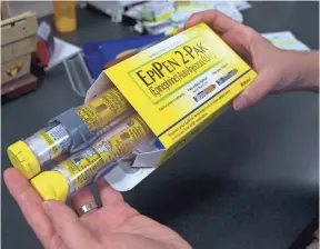  ?? RICH PEDRONCELL­I, AP ?? The price insurers and employers pay for the EpiPen, which treats severe allergic reactions, has increased about 150% since 2009. Jackie Davis of Newport News, Va., has a son named Michael, 7, who has severe food allergies and went into anaphylaxi­s...