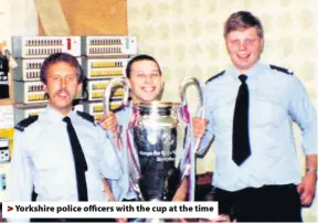  ??  ?? Yorkshire police officers with the cup at the time