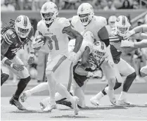  ?? AL DIAZ adiaz@miamiheral­d.com ?? The Dolphins’ Raheem Mostert, running against the Bills, said the offense has to be better at line calls to be effective on the ground.