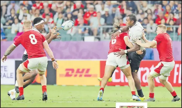  ?? Picture: JOVESA NAISUA ?? Leone Nakarawa offloads to Eroni Mawi during their RWC pool match against Wales at the Oita Stadium in Oita, Japan on Wednesday night.