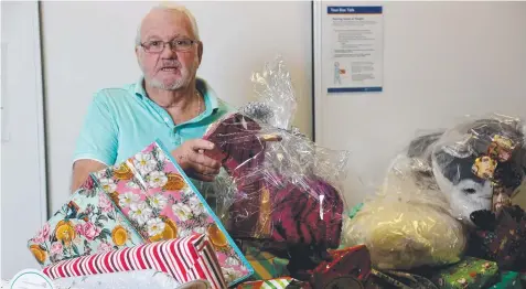  ?? Picture: STEWART McLEAN ?? REGIFTING: St Vincent de Paul state president Dennis Innes with donated presents.