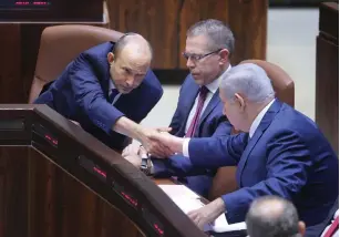 ?? (Marc Israel Sellem/The Jerusalem Post) ?? PRIME MINISTER Benjamin Netanyahu and Education Minister Naftali Bennett shake hands at the Knesset yesterday.