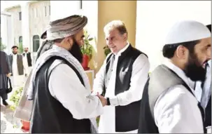  ?? AFP ?? Pakistan’s Foreign Minister Shah Mehmood Qureshi (centre, right) receives members of the Taliban delegation in Islamabad, Pakistan on Wednesday.