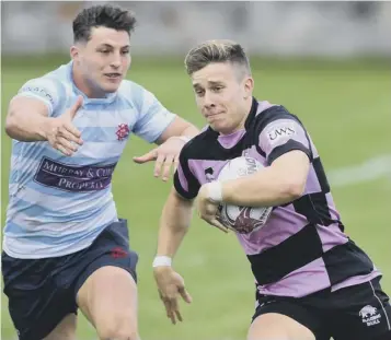  ??  ?? 0 Kyle Rowe, who scored two tries in an impressive debut for Ayr, bursts past George Spencer.