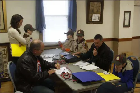  ?? PROVIDED PHOTO ?? Scouts from East Greenbush Pack 2257listen in as Amateur Radio operator Don Mayotte, KB2CDX, helps them make a contact by shortwave radio during Jamboree on the Air.