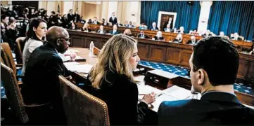  ?? ANDREW HARNIK/AP ?? Madeline Strasser, chief clerk for the majority on the House Judiciary Committee checks votes on an article of impeachmen­t.