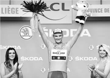  ??  ?? Germany’s Marcel Kittel celebrates his green jersey of best sprinter on the podium at the end of the 203.5 km second stage of the 104th edition of the Tour de France cycling race on July 2, 2017 between Dusseldorf, Germany and Liege, Belgium. - AFP photo