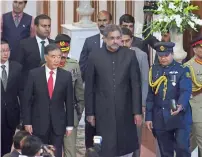  ?? AFP ?? Chinese Vice Premier Wang Yang and Prime Minister Shahid Khaqan Abbasi arrive to attend a flag hoisting ceremony in Islamabad. —