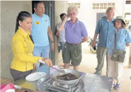  ??  ?? TASTES LIKE CRAB, APPARENTLY: A Cambodian woman frying tarantulas for tourists at Skun town in Kampong Cham province.