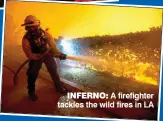  ??  ?? INFERNO: A firefighte­r tackles the wild fires in LA