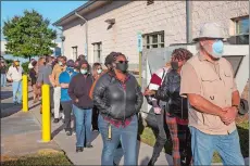  ?? JESSICA TEZAK/WASHINGTON POST ?? People wait in line Wednesday to cast their ballot on the first day of early voting at the Hamilton County Election Commission in Chattanoog­a, Tenn.