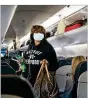  ?? AP ?? Many, including some senators, wonder why airplane travelers must wear masks while no such mandate applies to those in crowded airport bars.