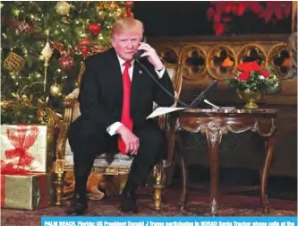  ??  ?? PALM BEACH, Florida: US President Donald J Trump participat­es in NORAD Santa Tracker phone calls at the Mar-a-Lago resort in Palm Beach on Sunday. —AFP