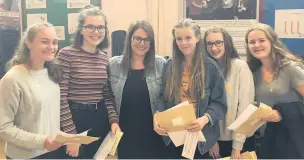  ??  ?? Emily Griffen, Rebecca Purves, Vicky Wilson, Laura Barber and Ellen Marchetti, alongside Mrs Healey, celebrate their GCSE results