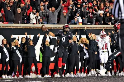  ?? The Associated Press ?? ■ Cincinnati quarterbac­k Desmond Ridder celebrates after catching a touchdown pass during the second half against SMU Saturday in Cincinnati. Cincinnati won 48-14.