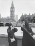  ?? REUTERS ?? Two women in burqas clicking photograph­s opposite the Houses of Parliament, London, Britain