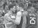  ?? JEROME MIRON/USA TODAY SPORTS ?? Devin Booker, left, and Luka Doncic exchange words in the fourth quarter on Sunday in Dallas.