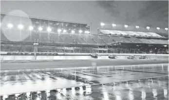  ?? JASEN VINLOVE, USA TODAY SPORTS ?? Air Titan track driers sit on the frontstret­ch Sunday during a rain delay in the Coke Zero 400.