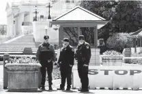  ??  ?? Members of the Capitol Police pay their respects Saturday at the site where Evans was killed.