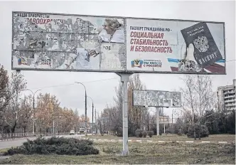  ?? ?? ABOVE
A Russian propaganda billboard in Kherson, Ukraine, days after the city was liberated, on Nov 13.