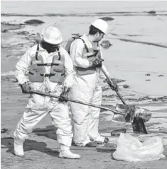  ??  ?? Garner Environmen­tal Services cleans up oil at East Beach on Tuesday.