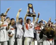  ?? NATI HARNIK — THE ASSOCIATED PRESS ?? Oregon State players and coaches celebrate with their mascot and the trophy after they beat Arkansas 5-0 in Game 3 to win the NCAA College World Series baseball finals, Thursday in Omaha, Neb.