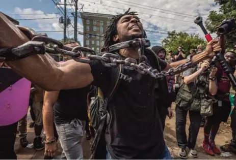  ?? EVELYN HOCKSTEIN/FOR THE WASHINGTON POST ?? Black Lives Matter activists take to the streets in a counter protest to the Unite the Right rally Saturday in Charlottes­ville, Va.