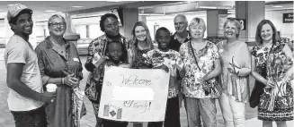 ?? CONTRIBUTE­D ?? Members of Pictou County Safe Harbour greet refugees at the airport the organizati­on has helped resettle to Canada. Since 2016, 11 families from Syria and the Democratic Republic of Congo have come to Pictou County.
