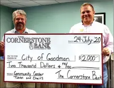  ?? PHOTO SUBMITTED ?? Mayor J.R. Fisher (left) of Goodman receives a donation of $2,000 for chairs and tables for the new community building from Michael Griffith (right), a representa­tive from The Cornerston­e Bank.